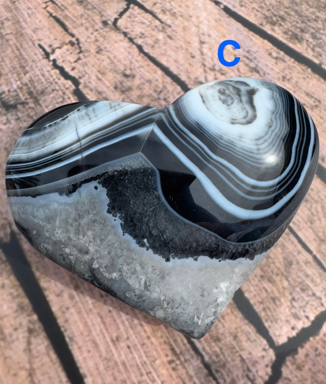Heart shaped black stripe agate stone with polished surface and natural banding patterns from Davinas