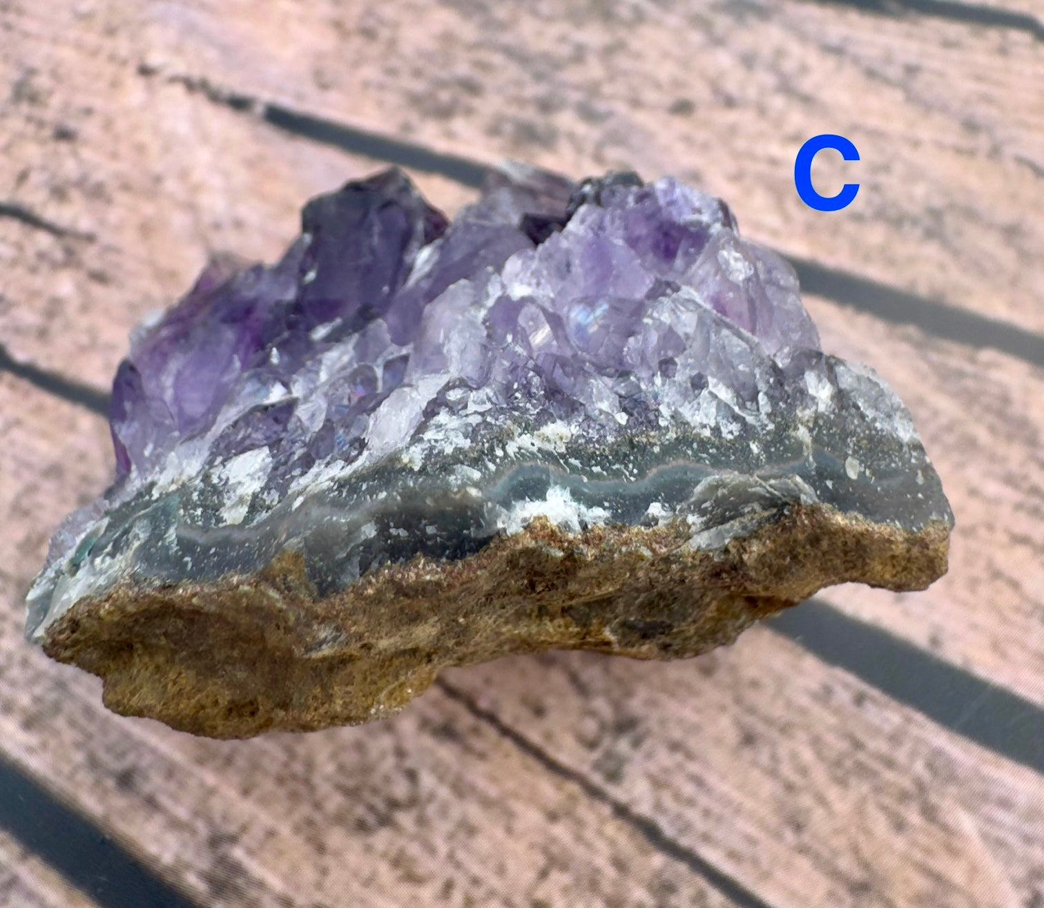 Davinas amethyst raw crystal cluster with purple and white crystals on natural brown rock base