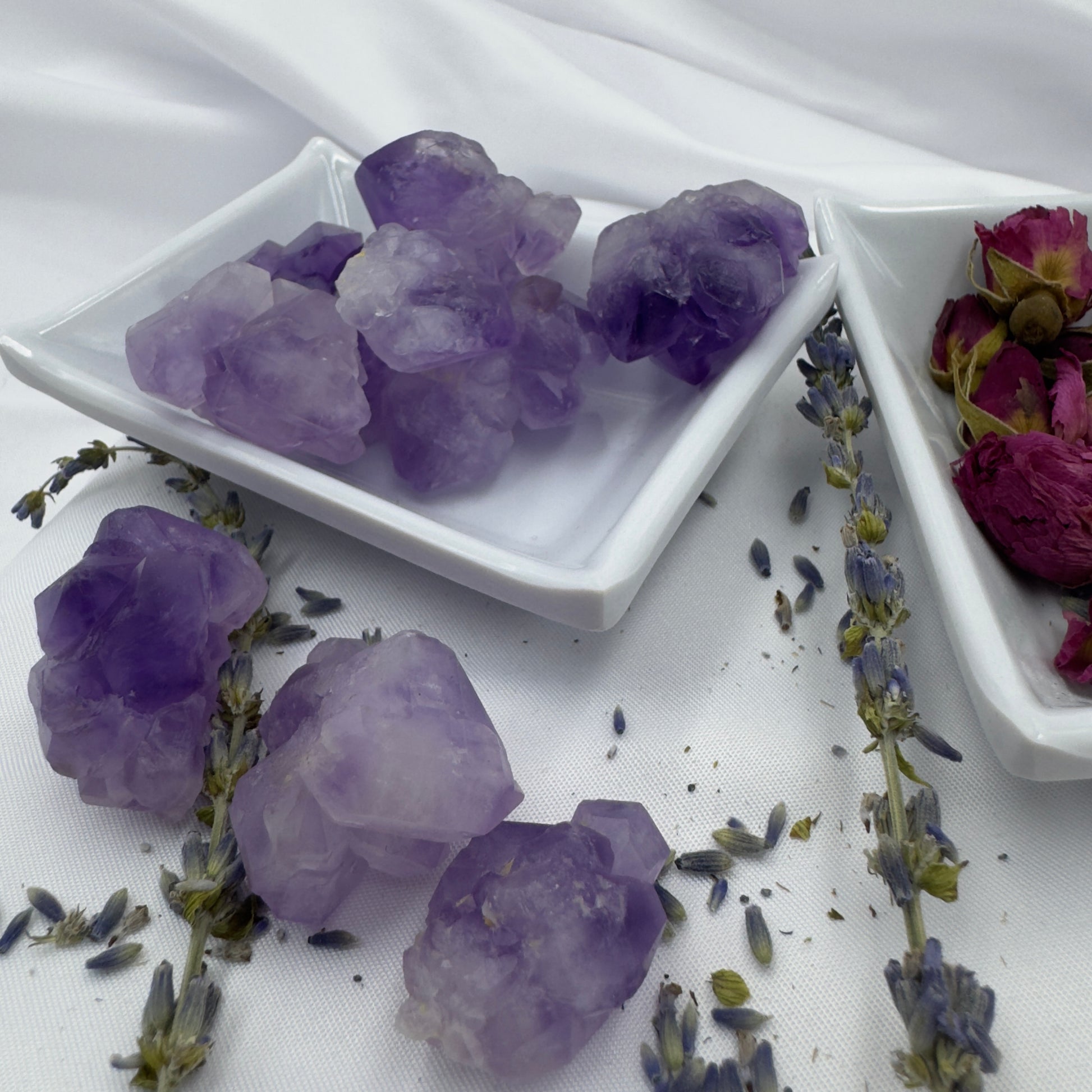 Buy amethyst mini clusters displayed on white ceramic dishes with dried lavender and rose petals