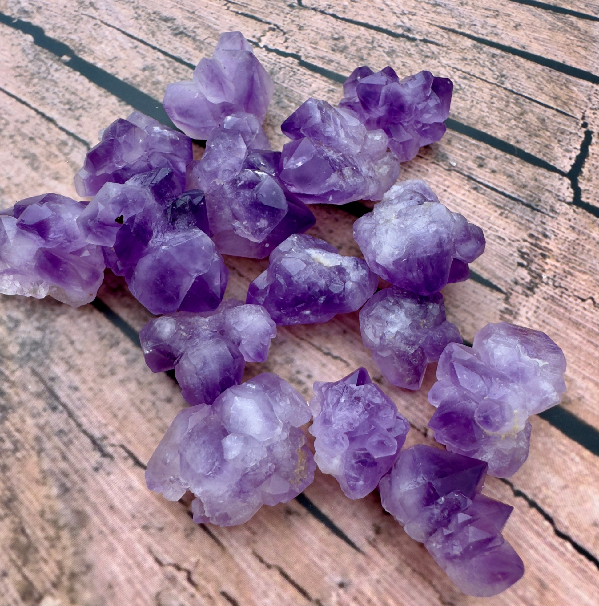 Davinas amethyst mini clusters in various shades of purple on a wooden surface buy amethyst mini clusters