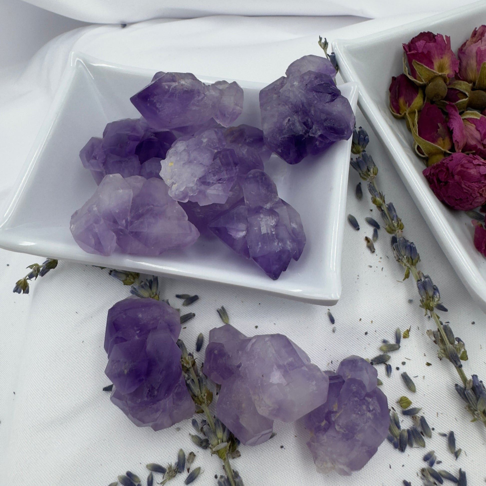Buy amethyst mini clusters displayed on white ceramic dishes with dried lavender and rose buds