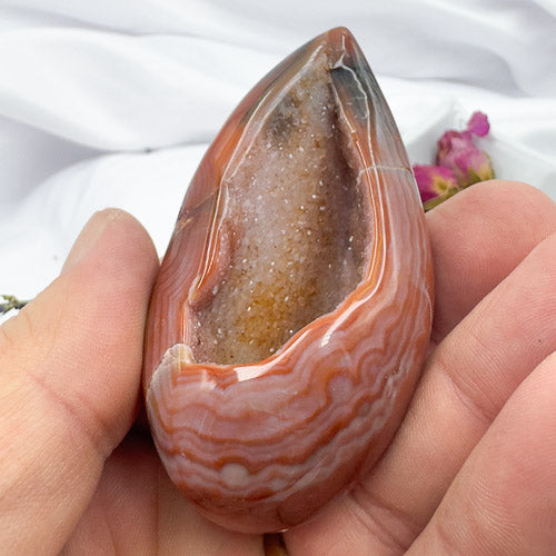 Davinas Carnelian Geode Druzy Freeform with natural orange and white banding held in hand