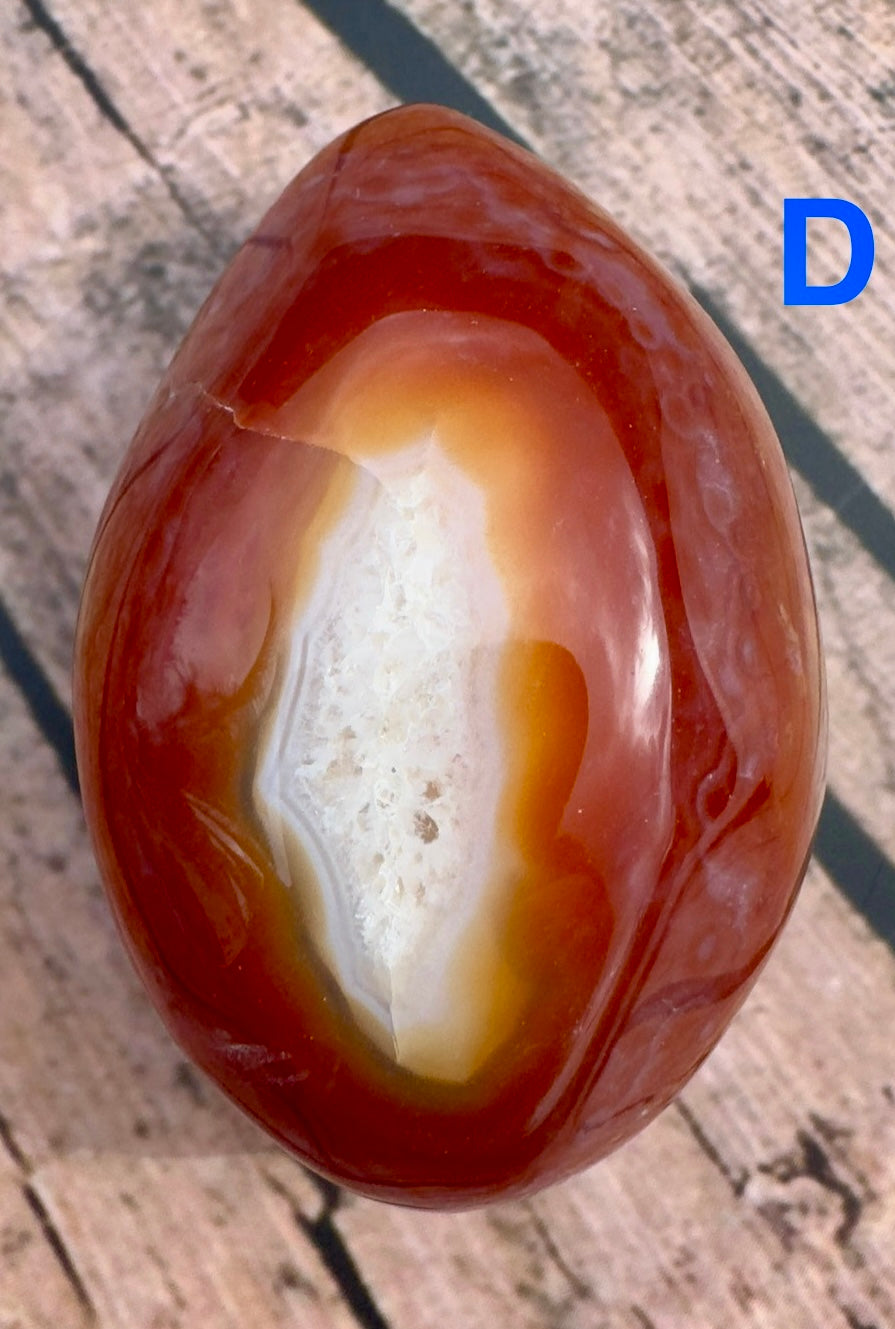Davinas Carnelian Geode Druzy Freeform with rich red and white crystal formations on wooden surface
