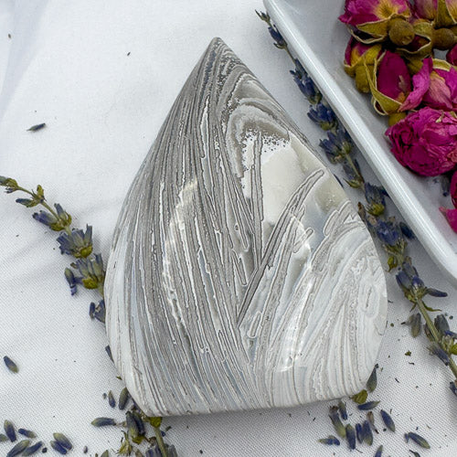 Handcrafted agate for collection with smooth polished surface and natural gray and white banding