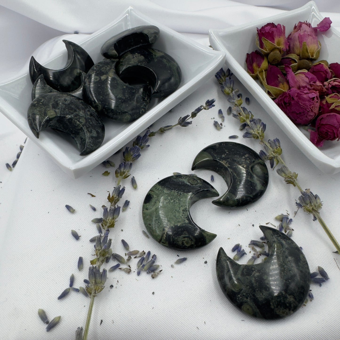 Davinas Kambaba Jasper Moon stone crescent shapes displayed with dried lavender and rose buds