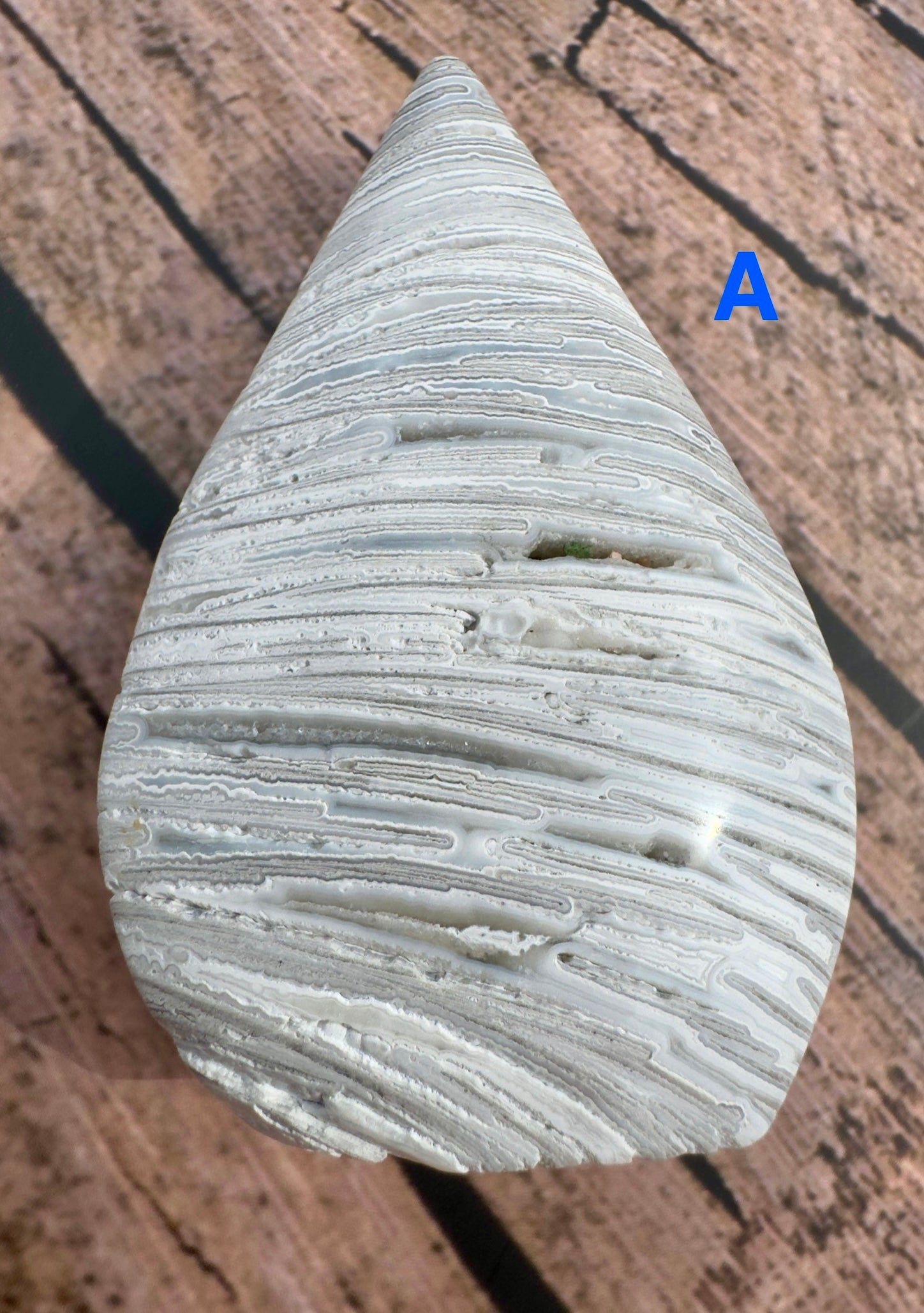 Davinas Morocco agate freeform stone with white and gray banded patterns and smooth polished surface