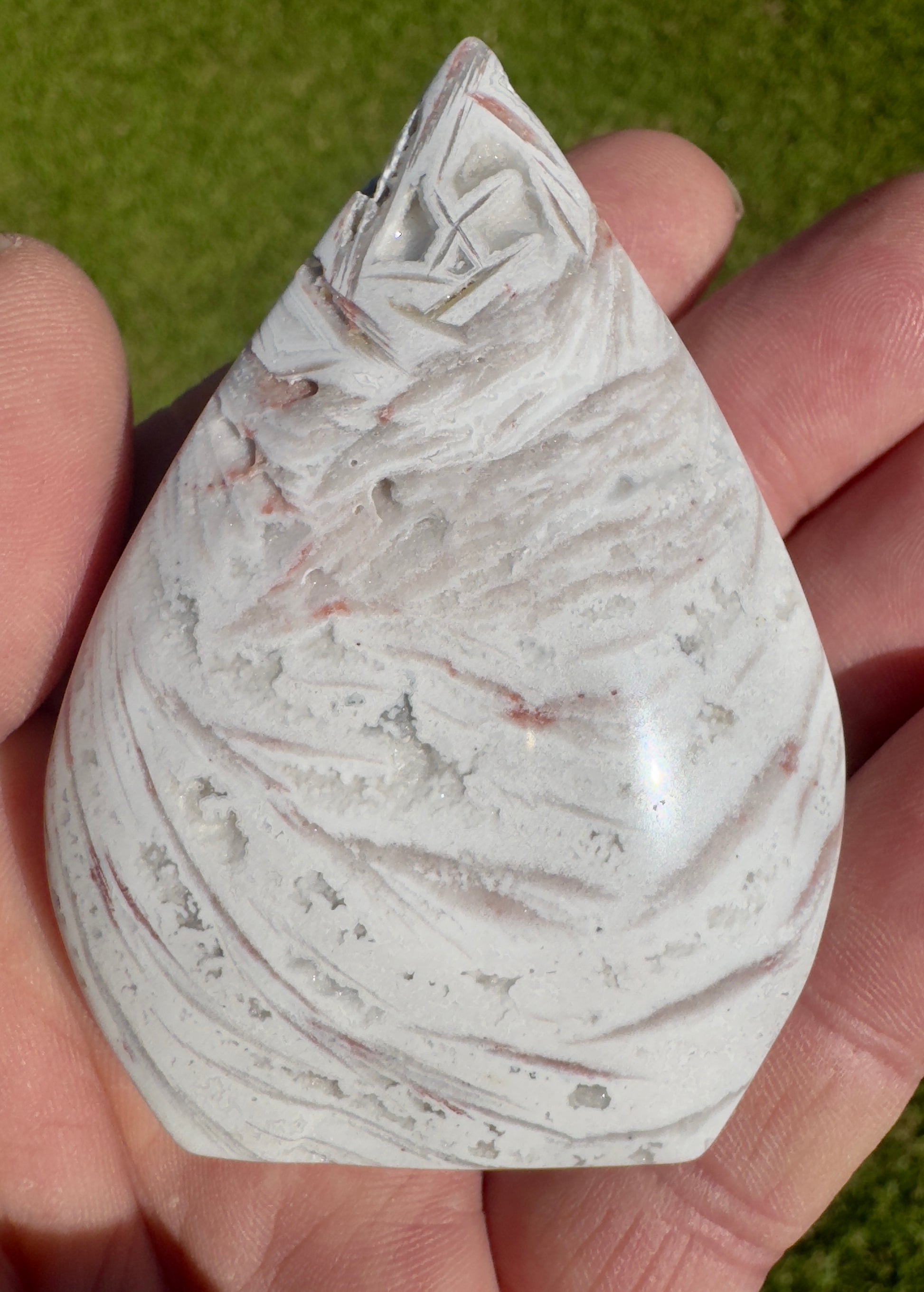 Davinas Morocco agate freeform stone with white and light brown banding held in hand