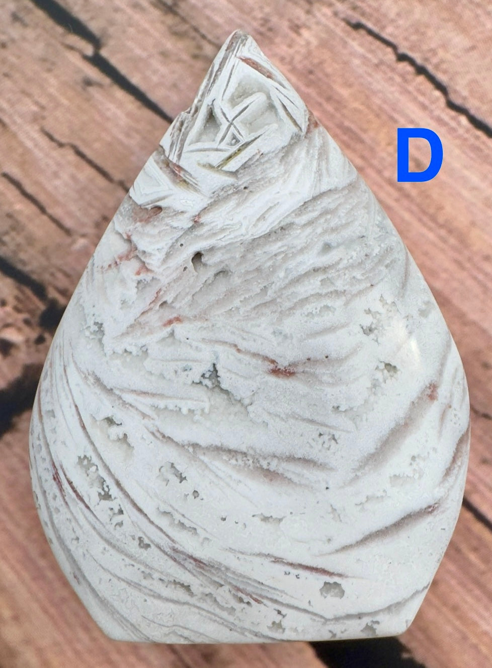 Davinas Morocco agate freeform stone with white and light brown layered patterns on wooden background