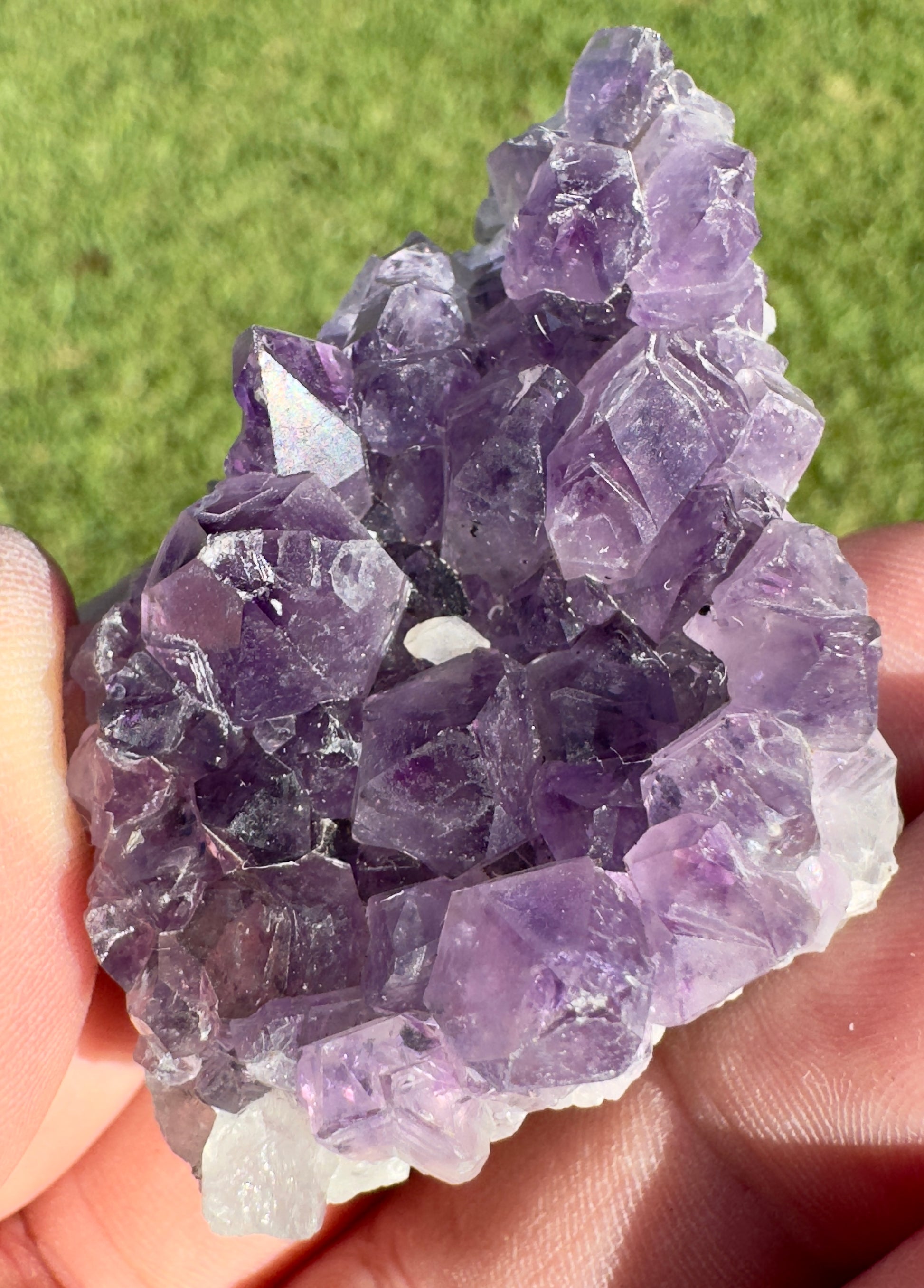 Davinas premium amethyst clusters held in hand showing vibrant purple crystal points