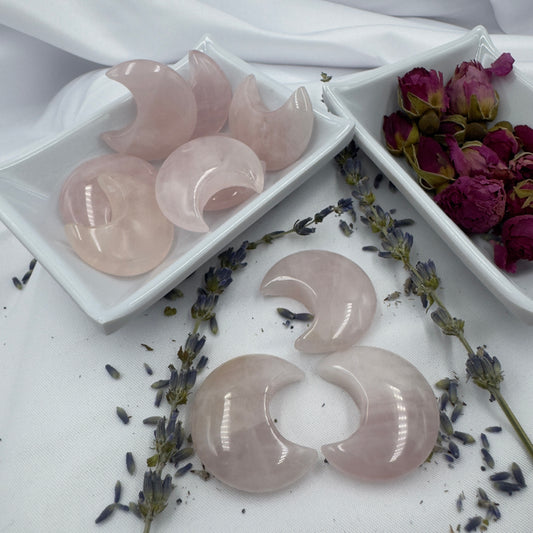 Davinas rose quartz moon crystal stones displayed with dried lavender and rose petals on white fabric
