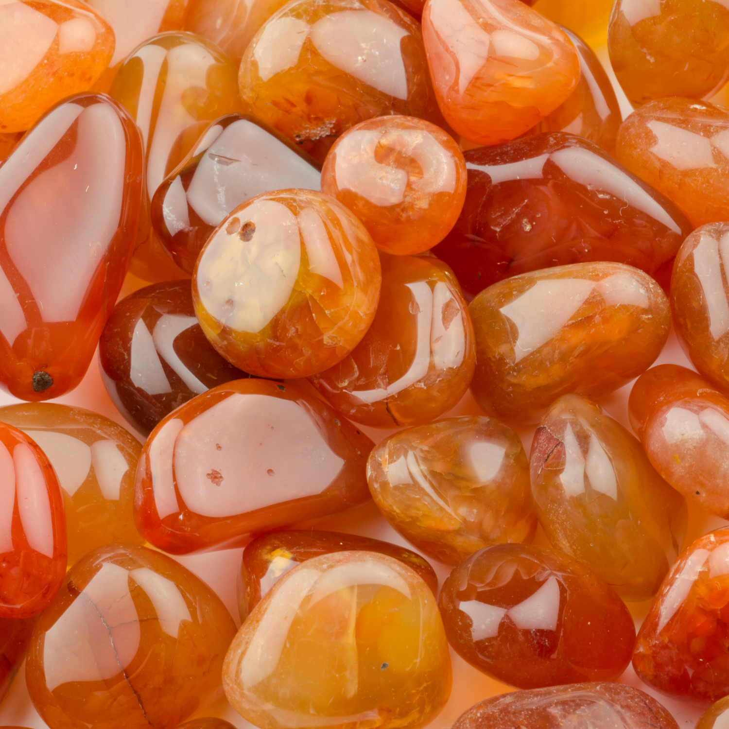 Close-up of polished carnelian stones showing vibrant orange and red hues carnelian for energy and creativity