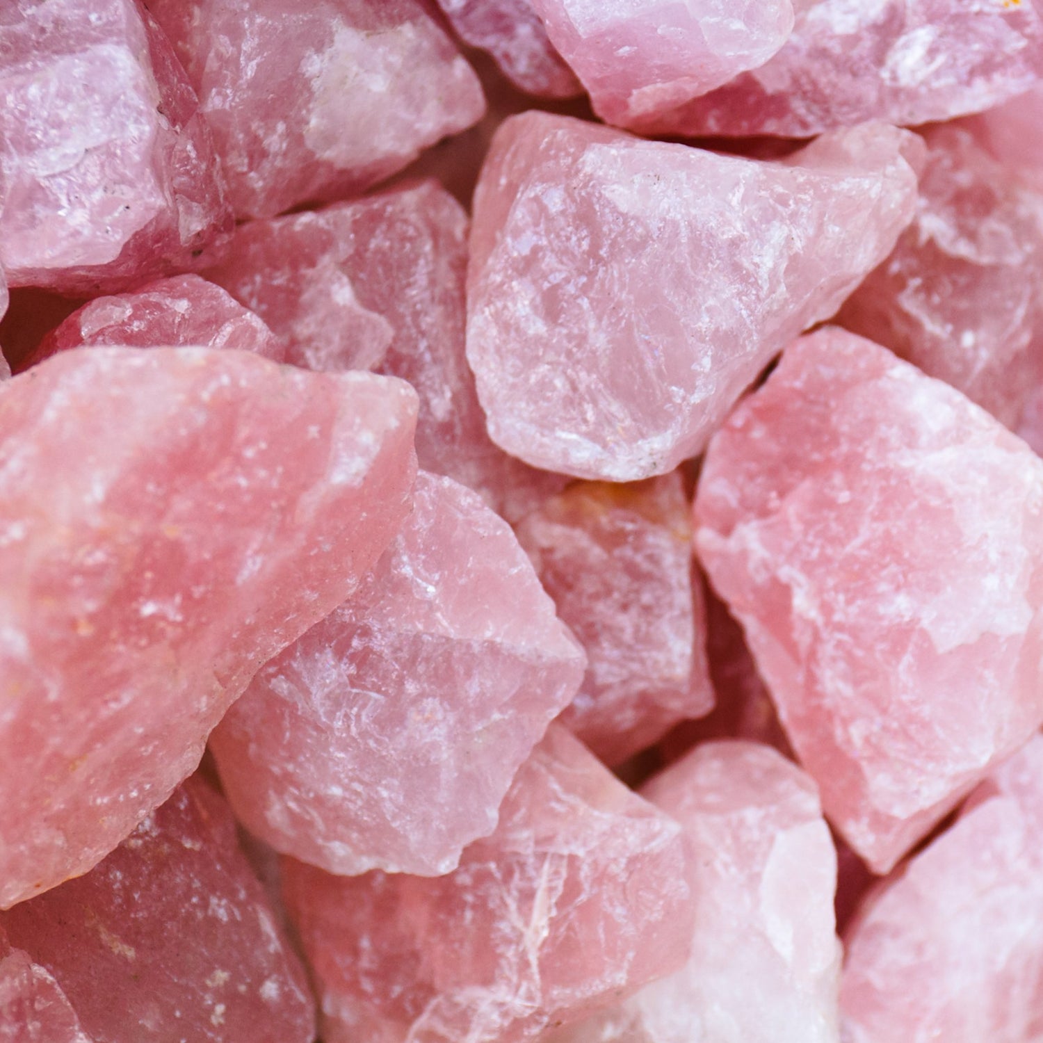 Close-up view of premium rose quartz stones with natural pink hues and rough textures