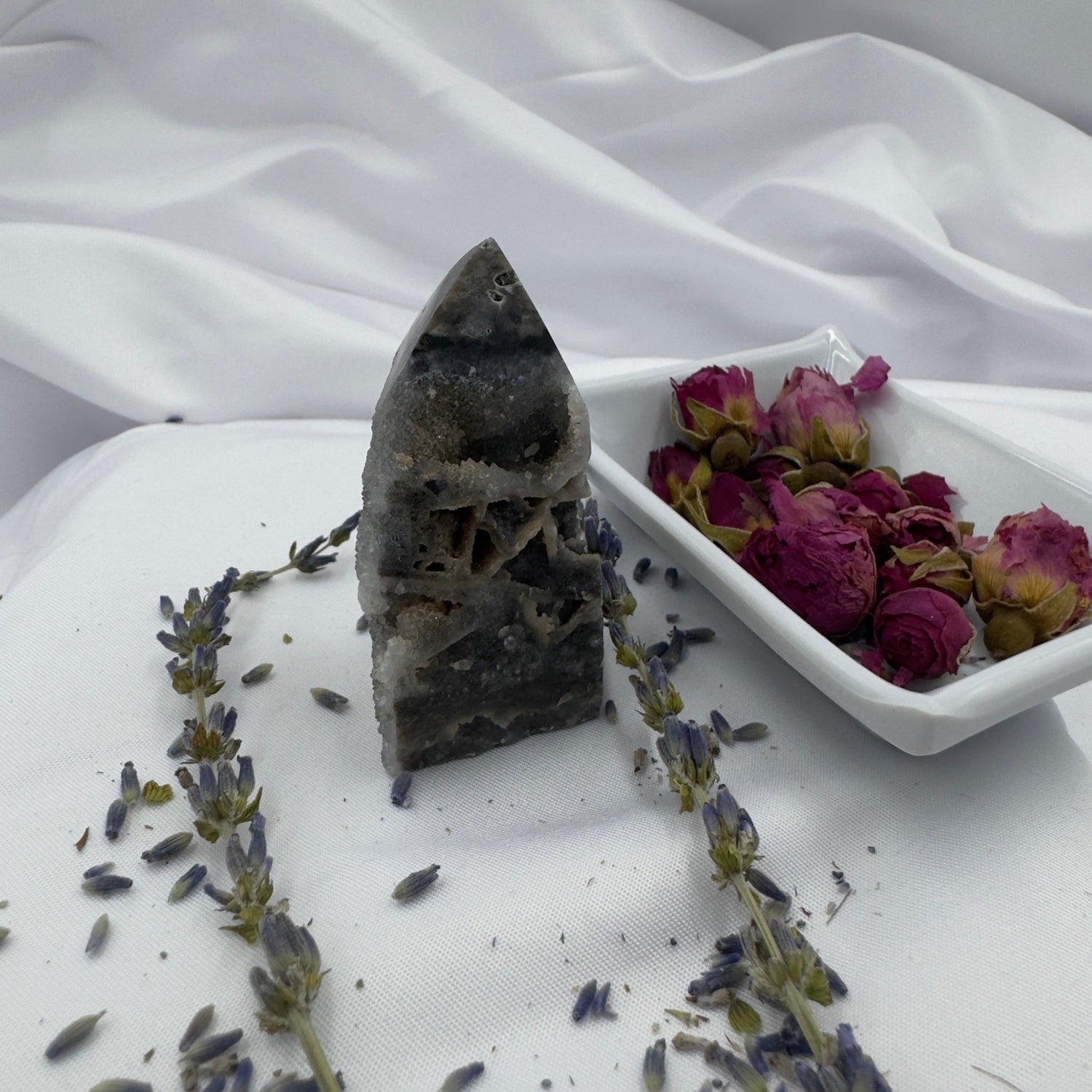 Premium Black Sphalerite gifts featuring a polished crystal point surrounded by dried lavender and roses