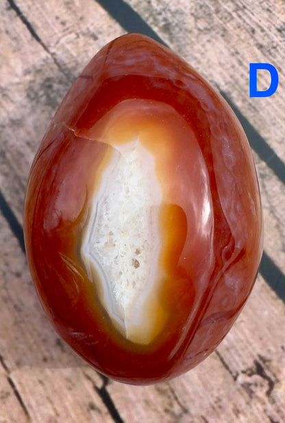Davinas Carnelian Geode Druzy Freeform with rich red and white crystal formations on wooden surface